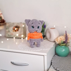 Cute amigurumi grey cat plush toy with an orange sweater, handmade in Poland. Cute amigurumi grey cat plush toy with an orange sweater, handmade in Poland.