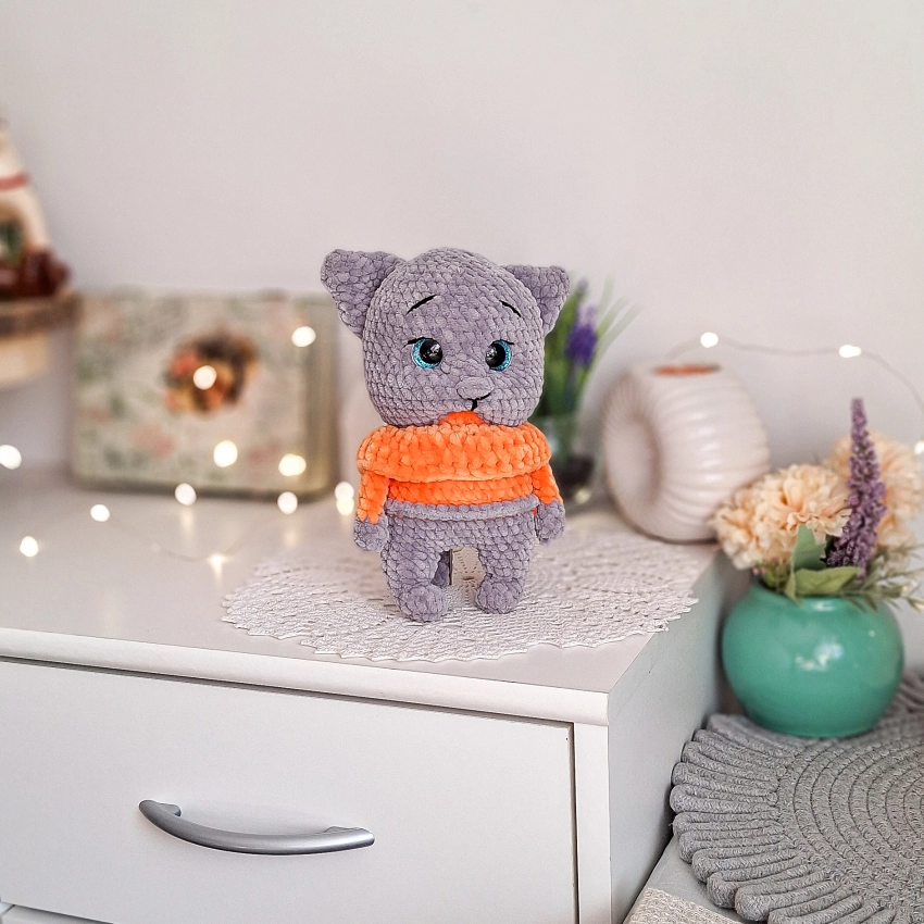 Cute amigurumi grey cat plush toy with an orange sweater, handmade in Poland.
